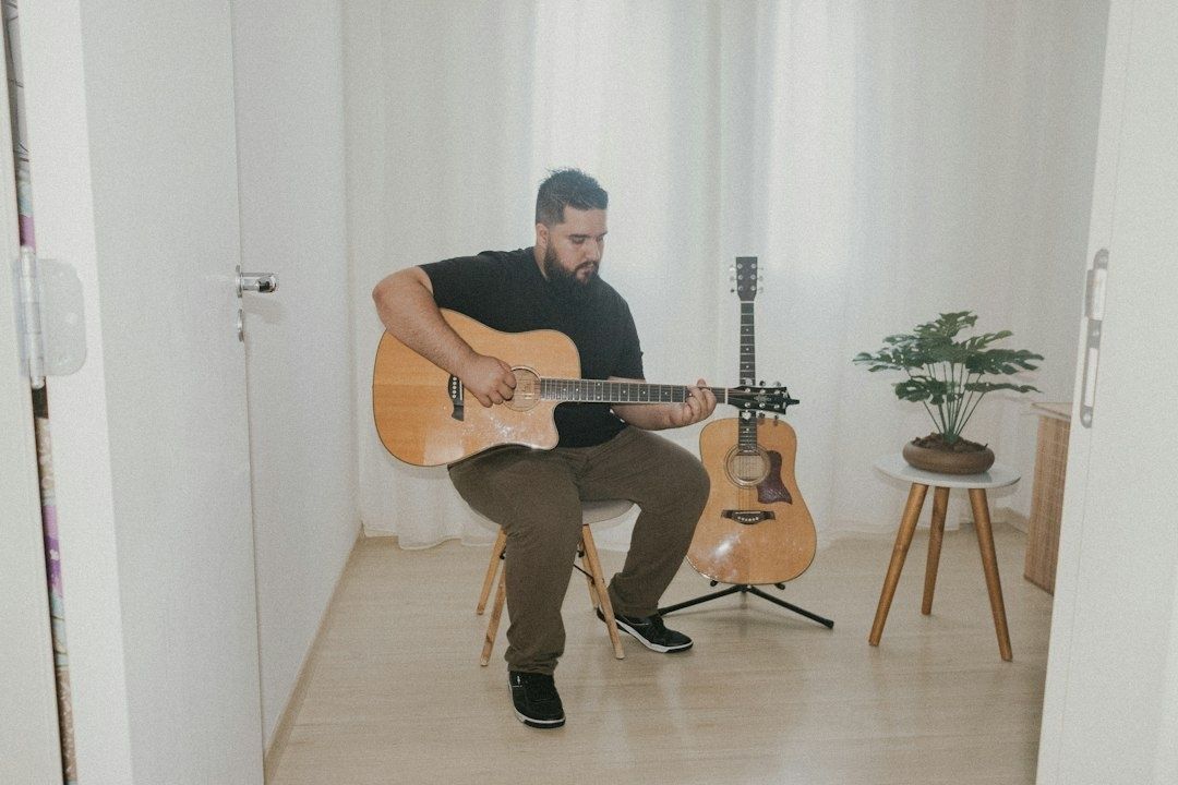 Musician calmly practicing acoustic guitar in a quiet room